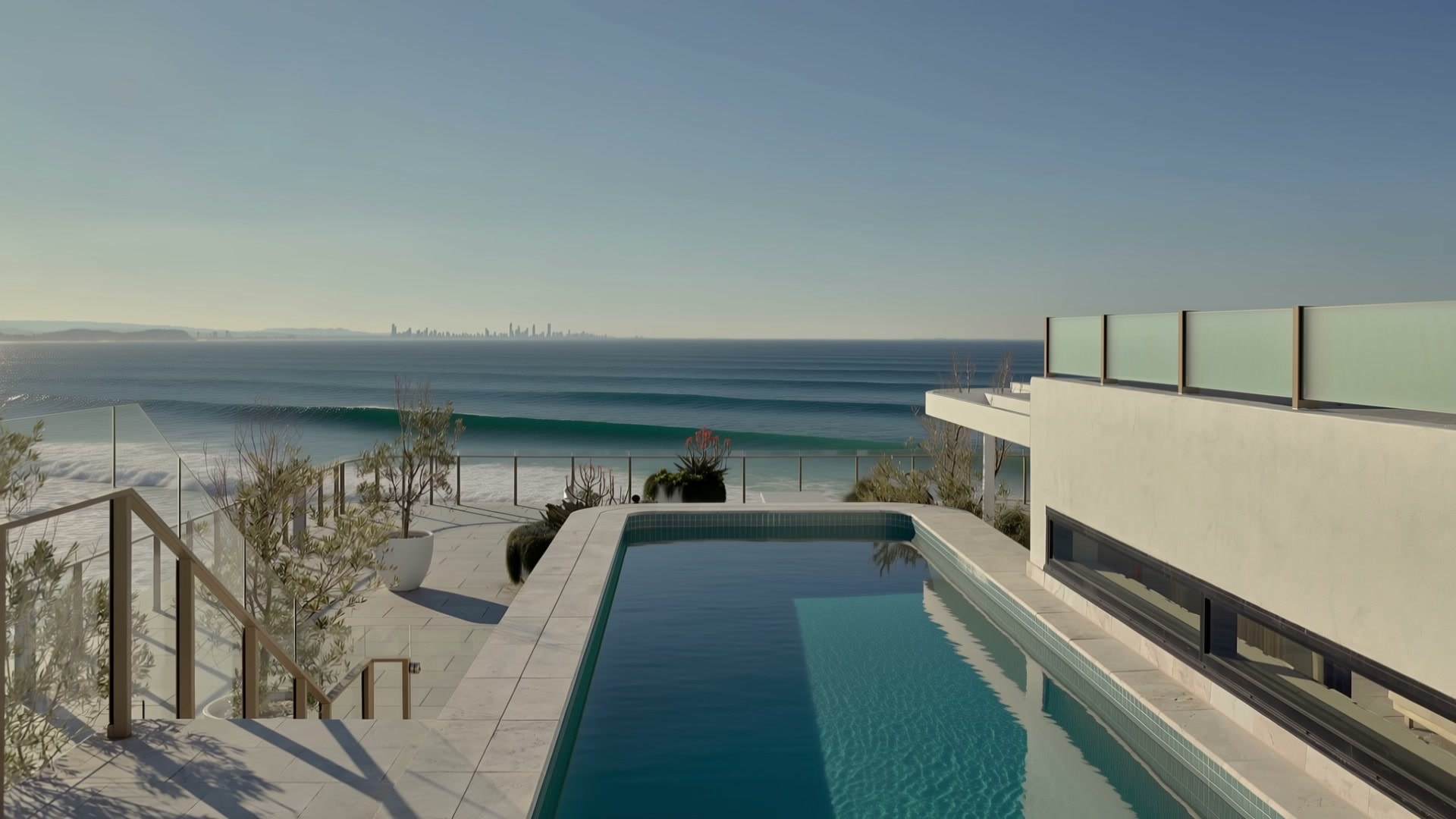 Flow Residences: a rooftop pool above the beach, a clean wave peeling past the glass fence with the skyline on the horizon